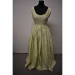 A pale green 1950s evening gown, having scoop neckline and full skirt.