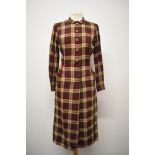 A 1940s plaid day dress, in burgundy, fawn and chestnut brown, having long sleeves, wooden buttons