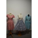 A 1950s abstract patterned textured cotton skirt, a 1960s dress having pink gingham and floral