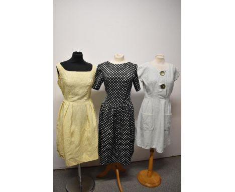 Three vintage dresses, to include 1950s day dress of textured cotton with large green buttons to bodice and two patch pockets