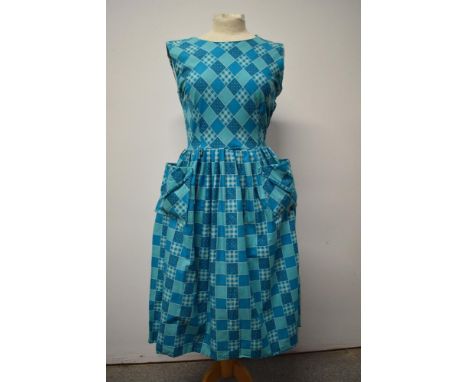 A 1950s turquoise blue cotton day dress, with patch pockets to front, gathered skirt and side metal zip which requires replac