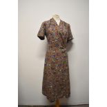 A 1940s slub cotton or cotton blend day dress, having heather coloured ground with bright blue and
