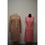 A 1960s tailored pink linen day dress with white stitching and a 1960s knitted green and pink