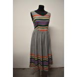 A 1950s light grey fine wool day dress, having colourful embroidery to hem and bodice, with fairly