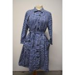A 1950s blue and white cotton shirt waister dress, having patch pockets to skirt and tie belt to