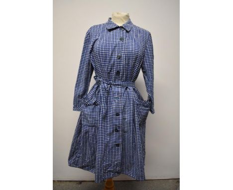 A 1950s blue and white cotton shirt waister dress, having patch pockets to skirt and tie belt to waist.
Bust approx 40 inches