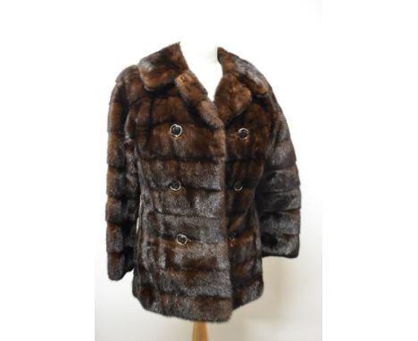 A mahogany coloured mink coat, having faux double breasted button detail and Capstick and Hamer label.
approx size uk 6 to 8.
