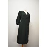 A 1930s bottle green day dress, having ladder work to sleeves and bodice, with cream twist detail to