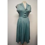 A late 1940s/early 50s day dress of sea foam green medium weight silk, having gathers to the
