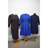 Three vintage dresses, including two 1960s shift dresses and a blue 1950s day dress with pleated