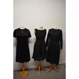 Three vintage 1960s black dresses.