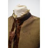 A Brown Victorian overcoat, having velvet trim, tassels to hem and sleeves and silk bow details (