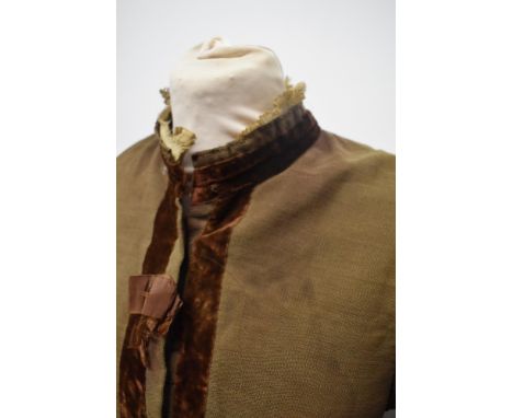 A Brown Victorian overcoat, having velvet trim, tassels to hem and sleeves and silk bow details (Shattered).