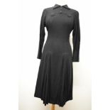 A stunning 1940s black wool day dress, having gathers of pleats to skirt with embroidered arrows,