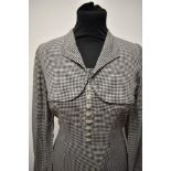 A fine dog tooth patterned 1950s day dress, having faux bolero effect to bodice, full length sleeves