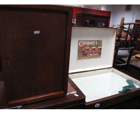 An Early XX Century Mahogany Hinged Display Case, glazed lower section, the inner lid with a later reproduction 'Cadbury's Ch