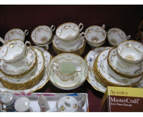 A Hammersley China Twelve Setting Tea Service, pattern number 14235, decorated with gilt swags and borders on a white ground,