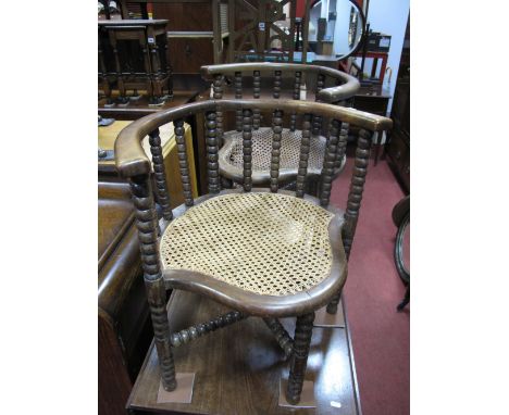 A Pair of XIX Century Corner Chairs, with bobbin decoration, caned seats, united by X stretchers.