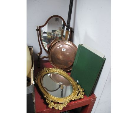 An Early XX Century Mahogany Toilet Mirror, shield mirror, shaped and scrolled supports and feet, a gilt cast iron oval mirro