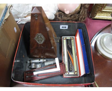 A Maelzel Metronome, Hohner Echo-Luxe Harmonica, tuning forks, whistles, etc