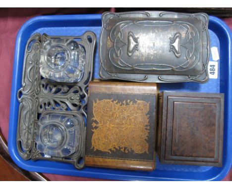 An Art Nouveau Cast Iron Desk Tidy, pierced stylised foliate frame with twin inkwells and pen rest, an Art Nouveau storage ti