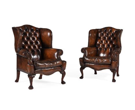 A PAIR OF MAHOGANY AND BUTTONED LEATHER UPHOLSTERED WING ARMCHAIRSIN GEORGE II STYLE, 20TH CENTURY each 112cm high, 86cm wide