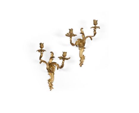 A PAIR OF LOUIS XV ORMOLU TWO LIGHT WALL LIGHTS  FRENCH, MID 18TH CENTURYModelled opposing, each with all over scroll and flo
