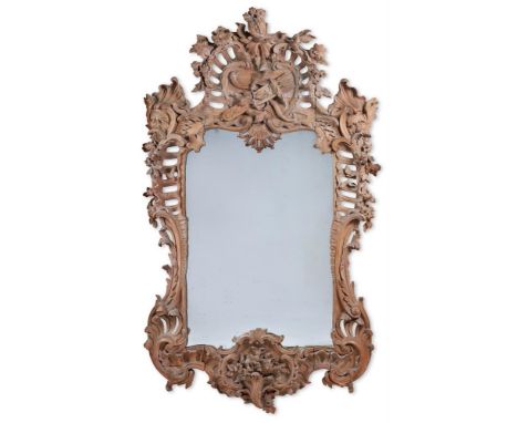 A FINELY CARVED PINE PIER MIRROR  IN THE MANNER OF MATTHIAS LOCK, EARLY 19TH CENTURY With shaped rectangular plate, the frame