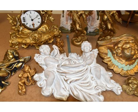 A LATE 19TH CENTURY GILT METAL MANTEL CLOCK AND A QUANTITY OF MODERN PLASTER CHERUB WALL PLAQUES, CANDLEHOLDERS, ETC, the clo