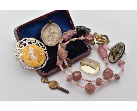 A SELECTION OF SILVER AND WHITE METAL JEWELLERY, to include an enamel Siam brooch, a silver locket, a moss agate ring, a face