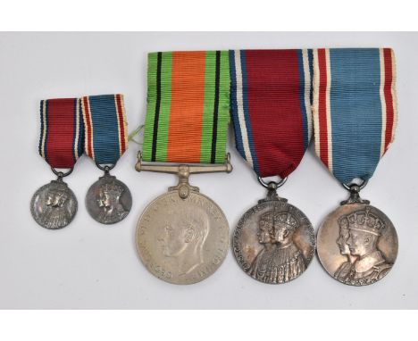 THREE MEDALS AND TWO MINIATURE MEDALS, to include a WWII defense medal, and two 'George V and Queen Mary' silver Jubilee meda