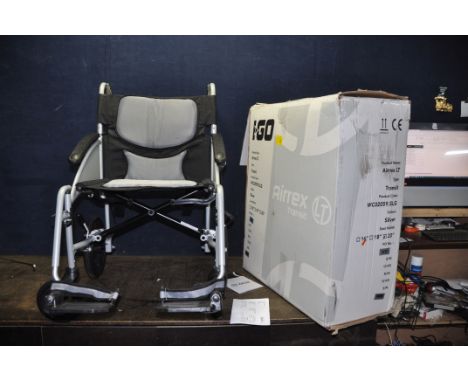 A BRAND NEW IN BOX IGO AIREX LT FOLDING WHEELCHAIR with manual and two footrests