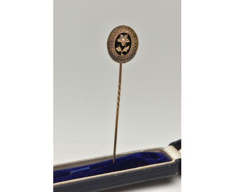 A VICTORIAN CASED STICK PIN, yellow metal unmarked, oval Etruscan pin, decorated with a rose cut diamond and split pearl set 