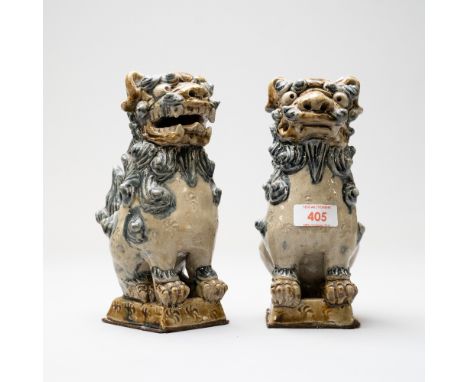 A pair of Chinese Tibetan styled figures of two dogs of Fo / Foo imperial temple guardian lions or Shishi. Both having a ston