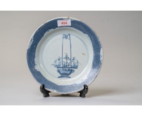 A Chinese or Japanese export plate in hard paste ceramic hand painted with flower basket scene and a blue boarder having circ