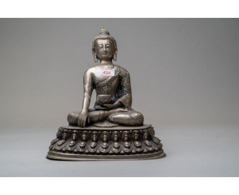 A seated Chinese Tibetan Buddhism Sakyamuni Buddha statue sat atop lotus leaf and sat in a meditation pose holding and offeri