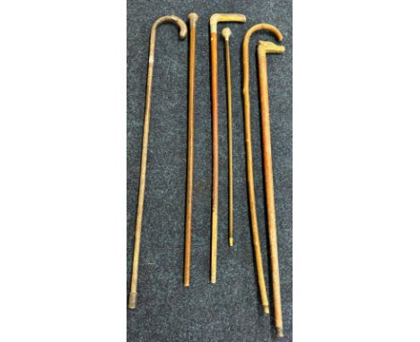 A Collection of antique and vintage walking sticks and canes; The Kings Royal Rifle Corps swagger stick, Two silver topped wa