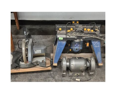 A collection of three power tools; Pro table top saw, table grinder &amp; large table saw