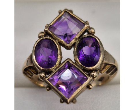 9ct yellow gold ladies ring fitted with four various cut amethyst gem stones, Emerald and oval cut stones. [Ring size O] [4.9