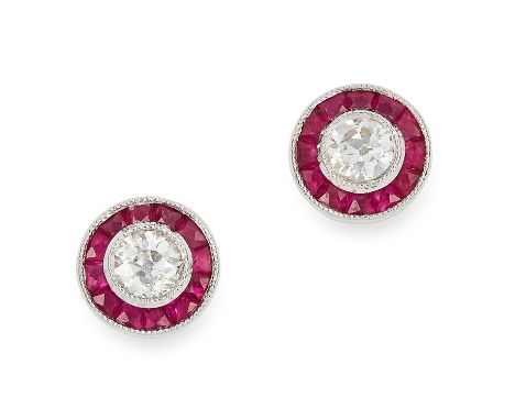 RUBY AND DIAMOND EARRINGS in 18ct white gold, each set with a round cut diamond in a border of step cut rubies, stamped 18K, 