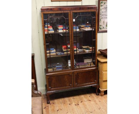 1920's mahogany cabinet bookcase having two glazed panel doors above two cupboard doors on ball and claw legs, 106cm by 175cm