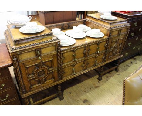 Early 20th Century Jacobean style oak sideboard having sunken centre with two drawers flanked by two drawers and two carved p
