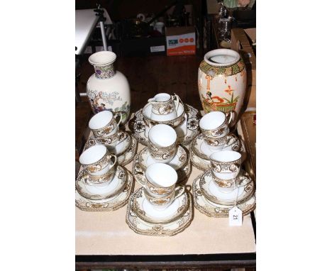Forty one piece Noritake gilt decorated tea service and two Oriental pottery vases