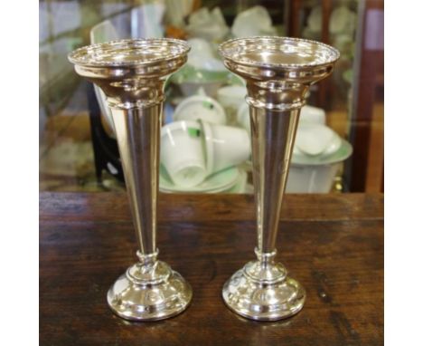Pair of sterling silver vases hallmarked Birmingham 1919, loaded bases, 20cm high approx.