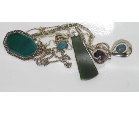 Three pendants and a brooch mostly silver with an opal tie pin