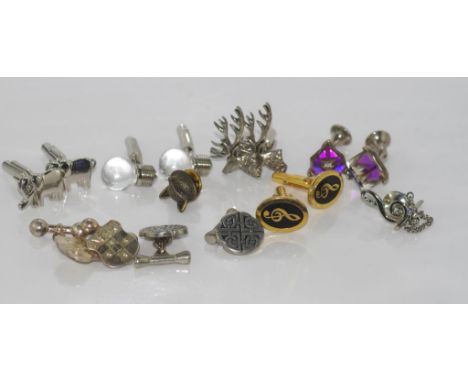 Seven pairs of cufflinks including elephant, elk, silver shields and a pair with music theme together with fox head tie pin a