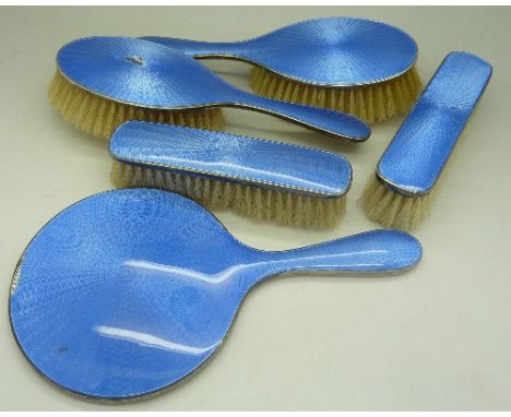 A five piece silver and guilloche enamel brush set, enamel a/f on one brush and hand mirror