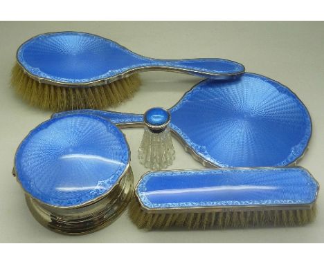 A silver and enamel dressing table powder pot, with matching mirror and two brushes and a silver and enamelled top bottle, Bi