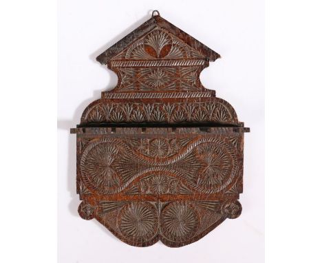 A small 19th century oak chip-carved spoon or pipe rackThe backplate with pediment cresting and scroll apron, profusely geome