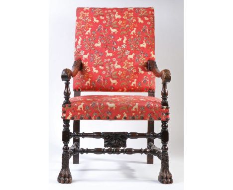 A 17th century walnut, oak and upholstered open armchair, FrenchThe rectangular padded back and stuff-over sear upholstered i